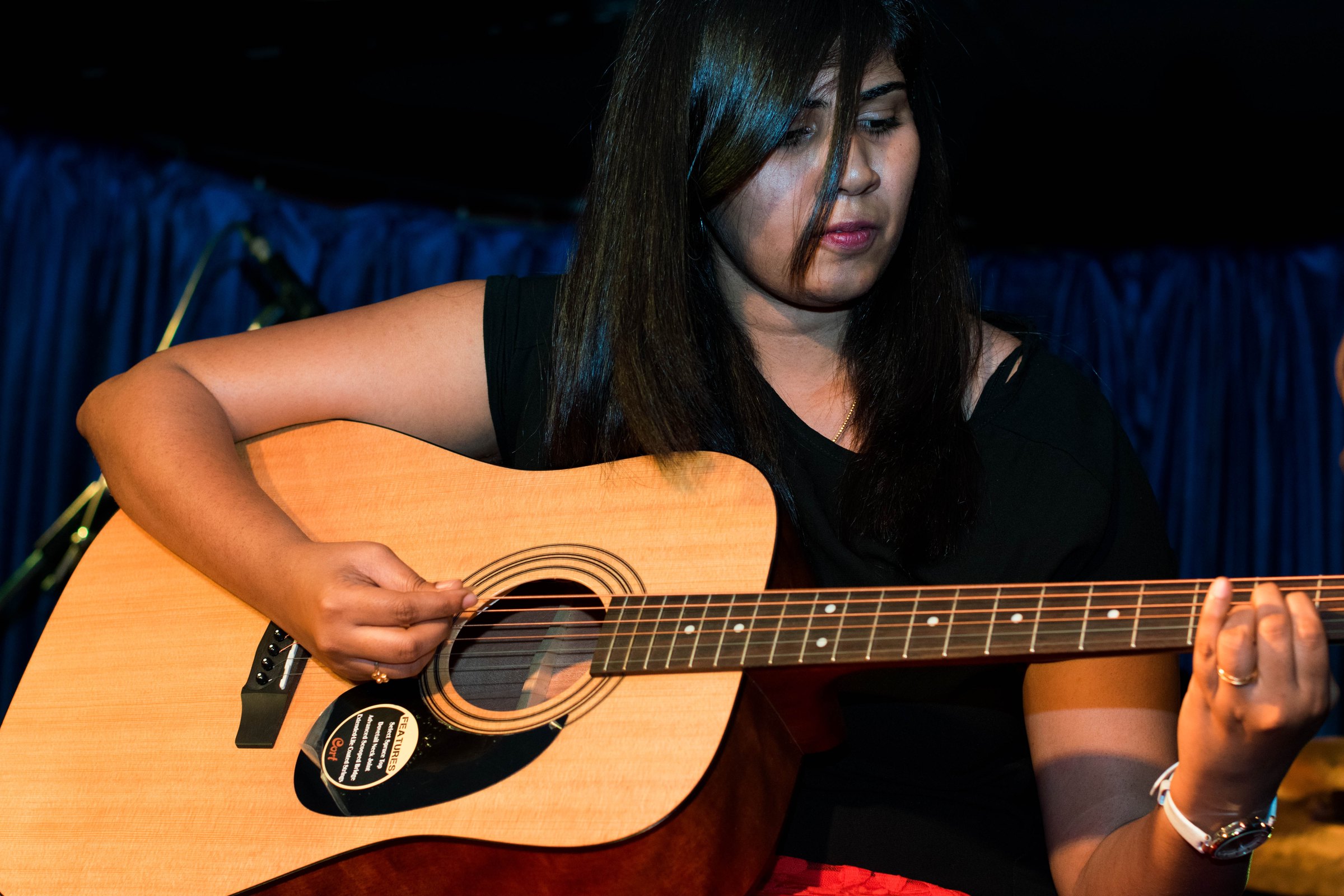Guitar student playing acoustic