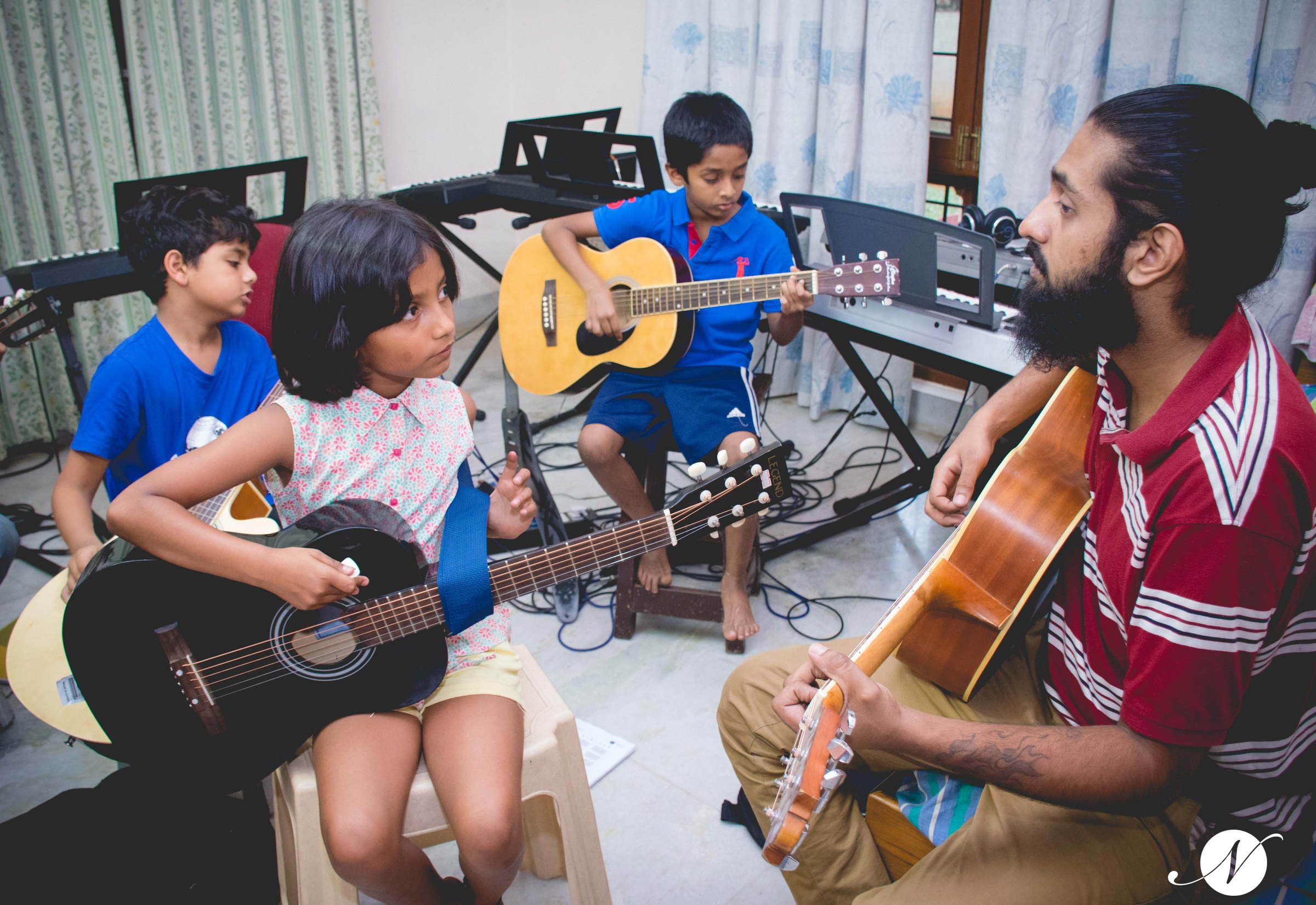 Children's guitar class with teacher