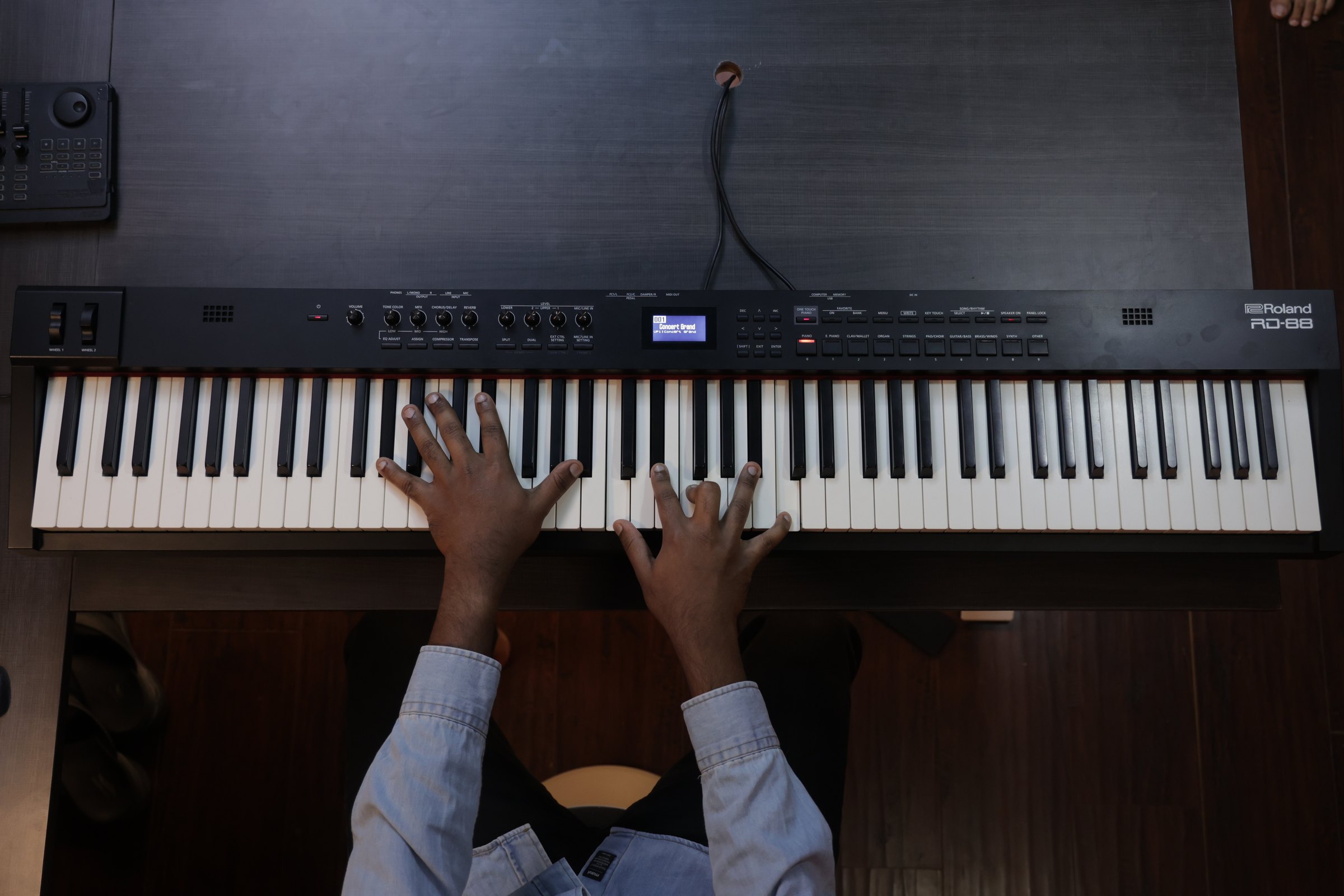 Top-down view of hands at the piano