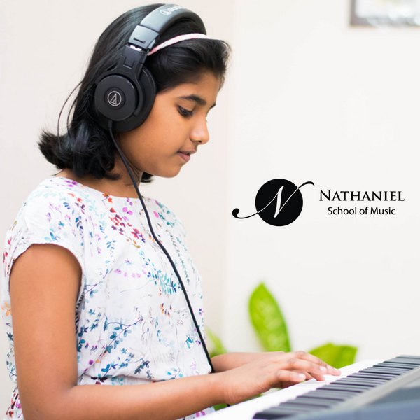 Young girl with headphones at the piano