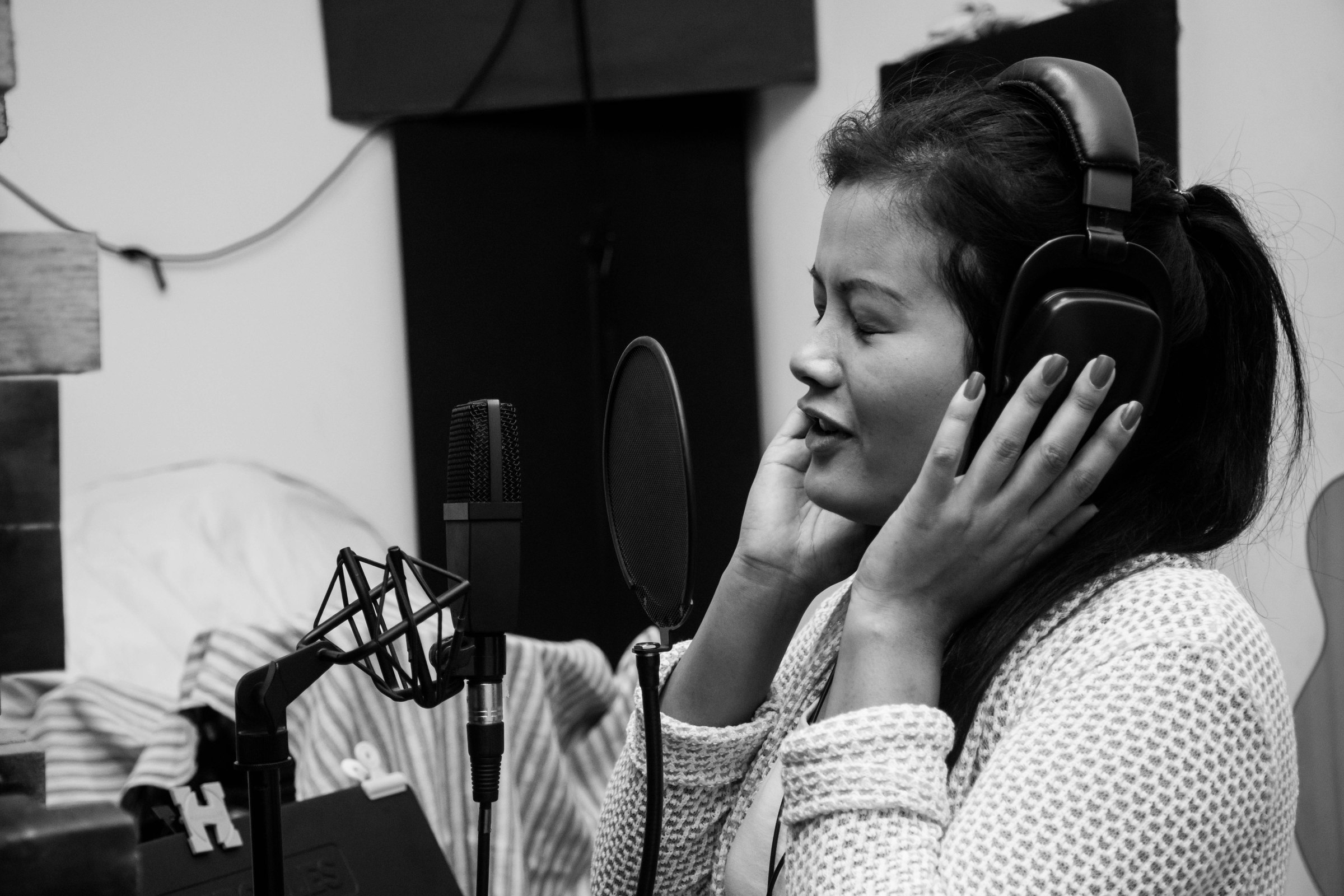 Singer recording into a studio microphone